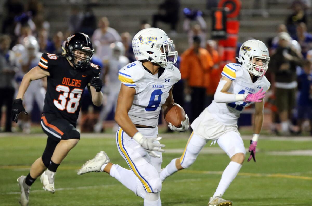 Fountain Valley's Ben Pham runs in the first quarter against Huntington Beach in the Sunset League football opener.