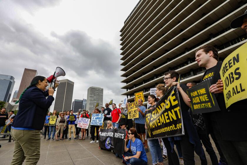 Irfan Khan??Los Angeles Times AT THE DWP, activists from Food & Water Watch and Sunrise Movement rally for solar power. The Eland project could supply 6% to 7% of L.A.’s power needs.