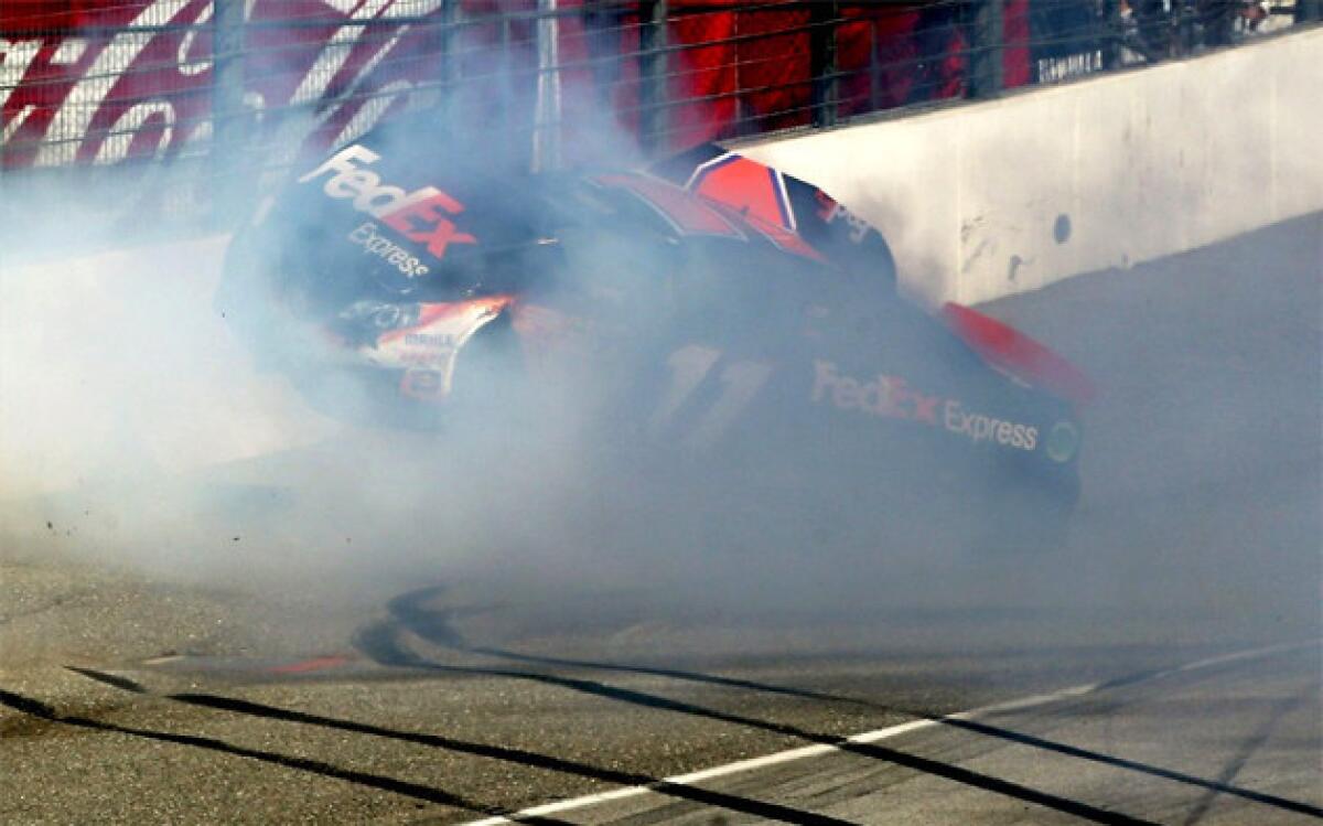 Denny Hamlin hits the wall after colliding with Joey Logano (not pictured) on the final lap.