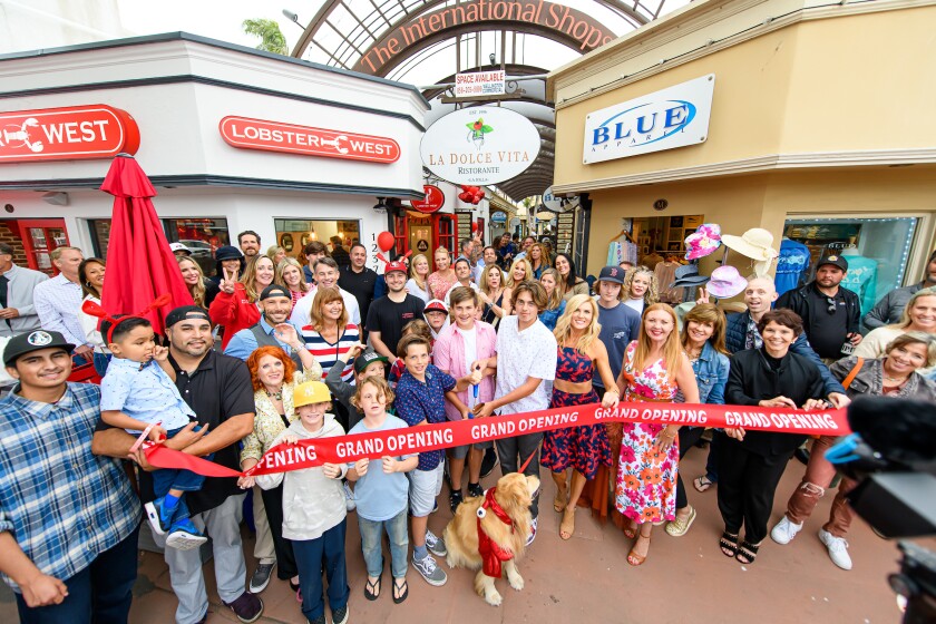 The Lobster West team cuts the ribbon on its new location at 1237 Prospect St. in La Jolla.