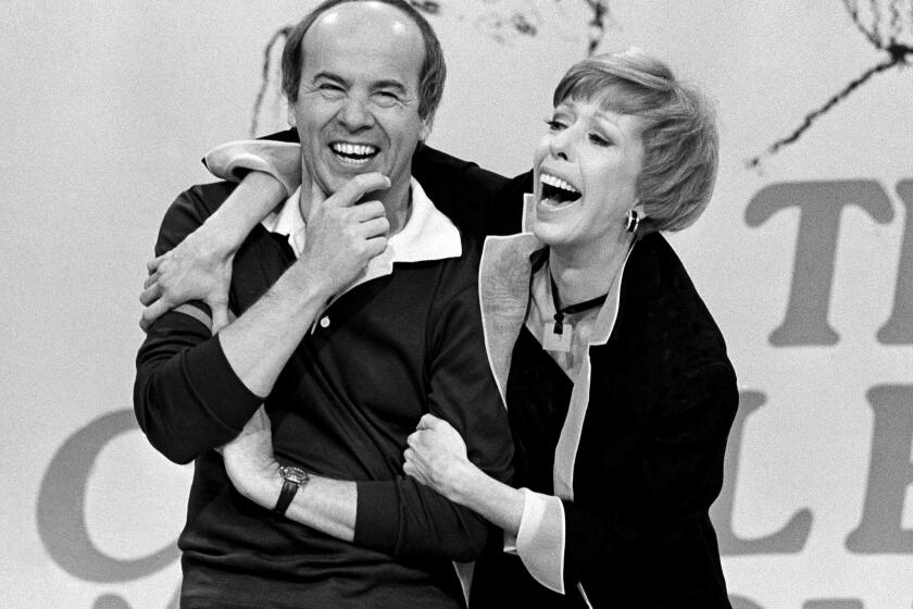 Comedian Carol Burnett laughs with co-star Tim Conway during the taping of the final episode of "The Carol Burnett Show" in Los Angeles on March 19, 1978. Conway, who won four Emmy Awards on the TV variety show, starred in "McHale's Navy" and later voiced the role of Barnacle Boy for "Spongebob Squarepants," died on May 14. He was 85. (AP Photo/ George Brich)
