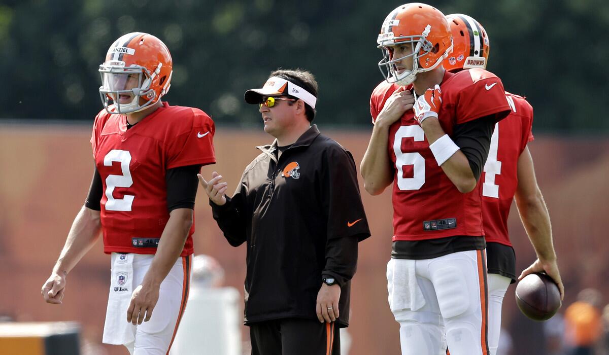 Cleveland Browns quarterbacks coach Dowell Loggains, center, talks with Johnny Manziel (2) and Brian Hoyer (6) during practice Wednesday.