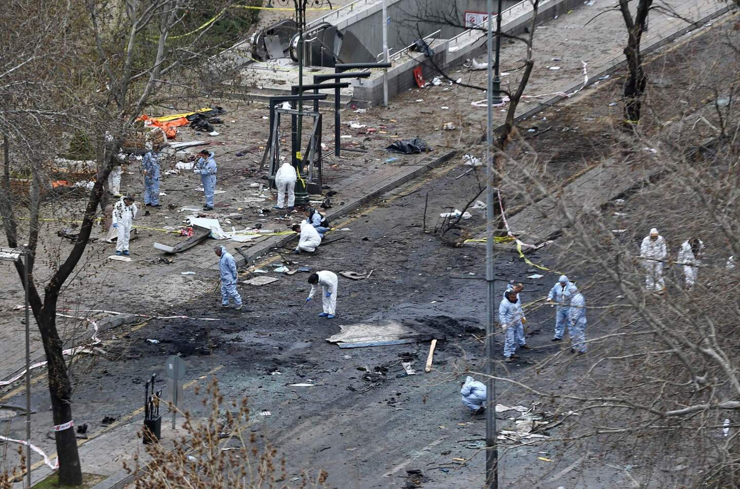 Forensic experts investigate the scene March 14, 2016, the day after a suicide car bomb ripped through a busy square in central Ankara killing at least 37 people and wounding 125, officials said.
