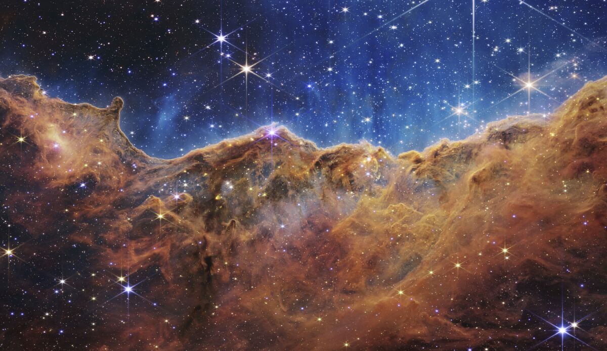 The edge of a young, star-forming region NGC 3324 in the Carina Nebula reveals previously obscured areas of star birth.