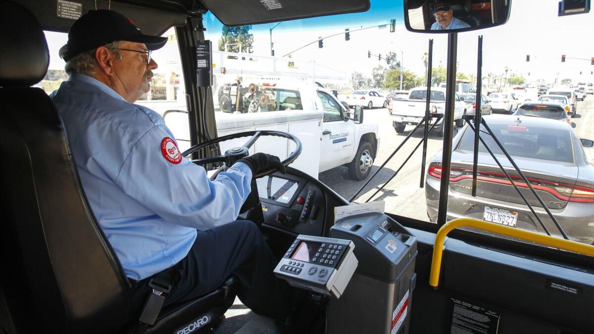 Bus driver Tom Middleton waits at a traffic light in San Diego. He used to have a career as a software engineer.