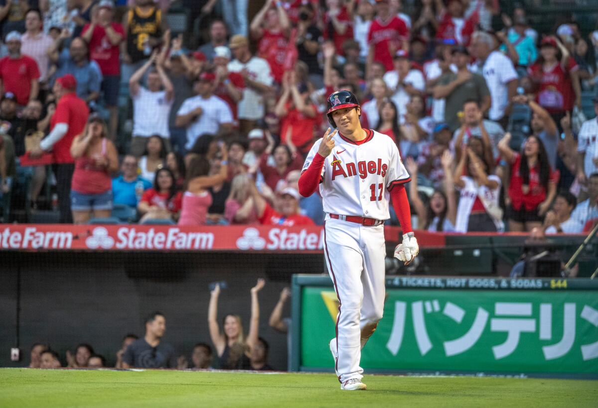 Shohei Ohtani celebrates after scoring on an RBI double by Mickey Moniak in the fourth inning against the Pirates.