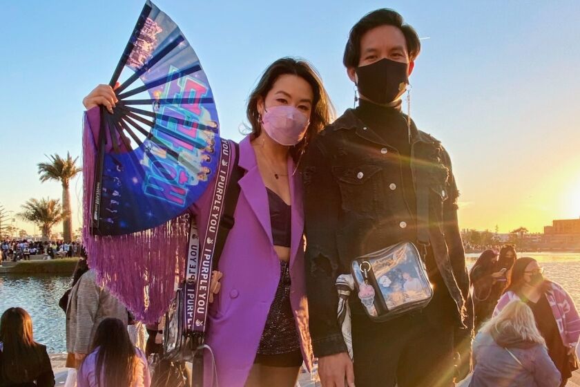 A man and woman dressed for the BTS concert