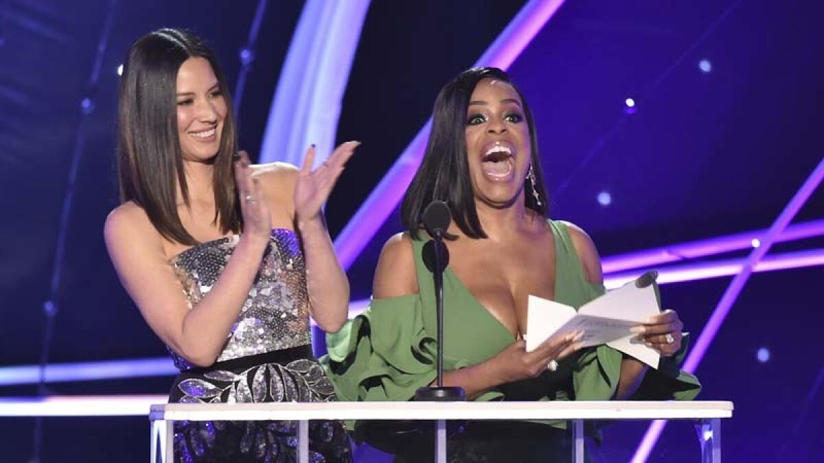 Olivia Munn, left, and Niecy Nash present the award for outstanding male actor in a drama series at the 2018 SAG Awards.