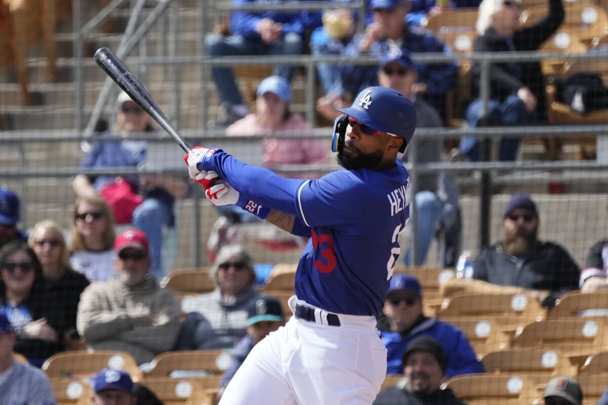 Dodgers outfielder Jason Heyward follows through with his swing in a spring-training game against the Arizona Diamondbacks.