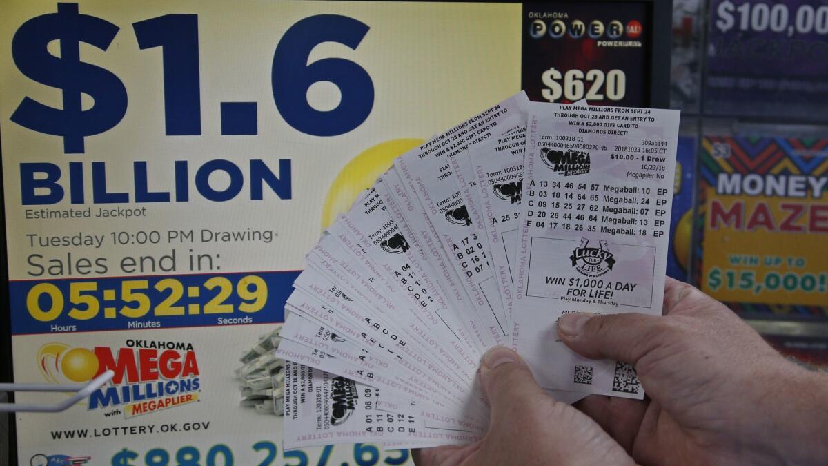 A customer who did not want to be identified displays $200 worth of Mega Millions tickets he bought in Oklahoma City on Tuesday.