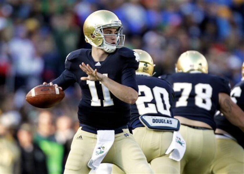 Notre Dame quarterback Tommy Rees throws against Navy during the first half of an NCAA college football game in South Bend, Ind., Saturday, Oct. 29, 2011. (AP Photo/Michael Conroy)