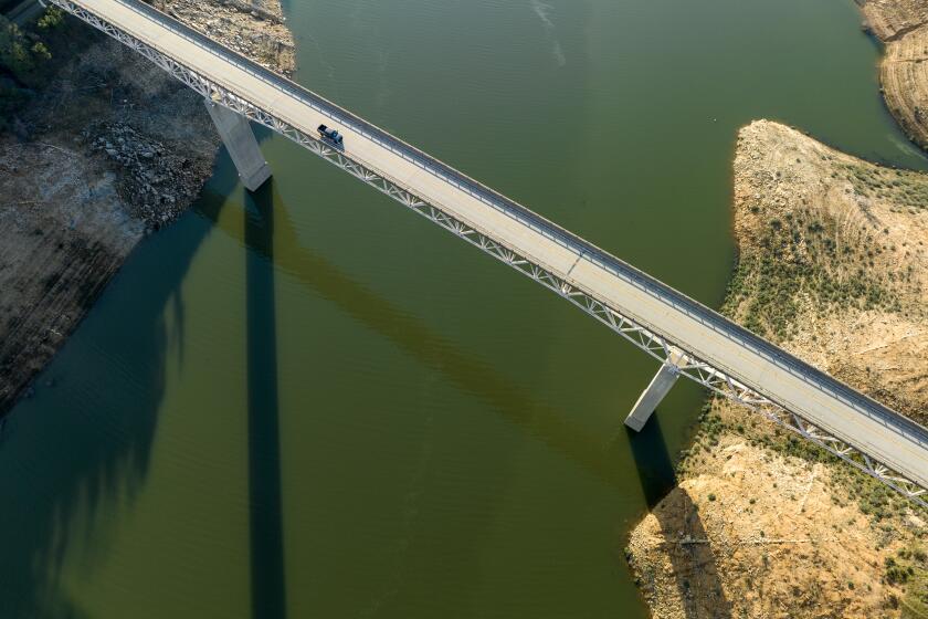 OROVILLE, CA - February 07, 2023: A vehicle crosses the Enterprise Bridge at Lake Oroville on Tuesday February 7, 2023 in Oroville, CA. (Brian van der Brug / Los Angeles Times)