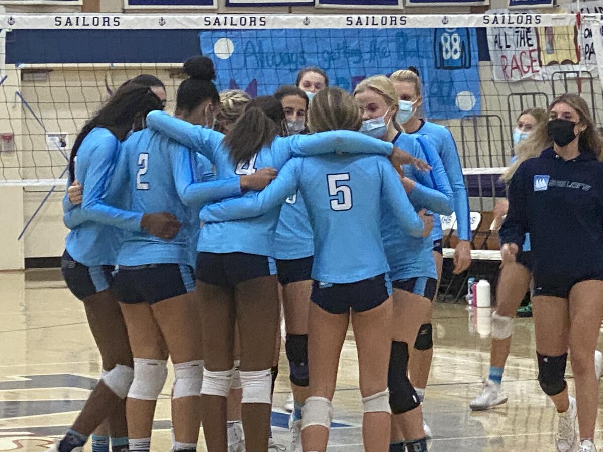 Marymount players converge during three-set sweep of Mira Costa in the CIF-SS Division 1 semifinals.