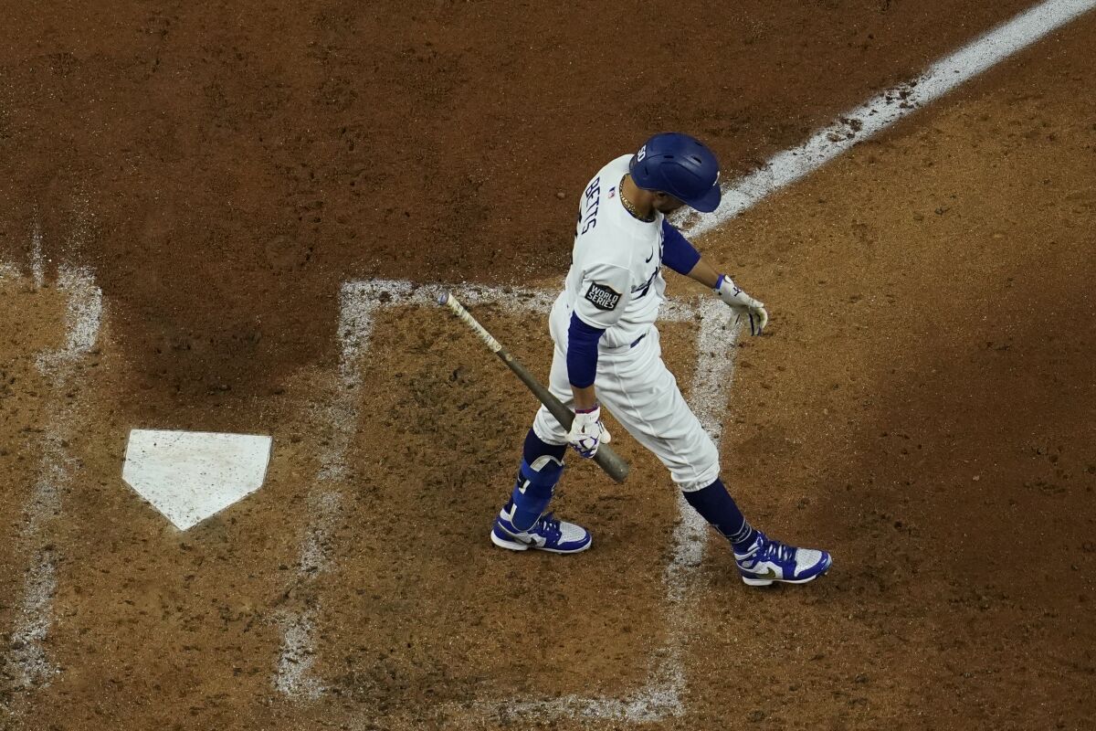 Dodgers right fielder Mookie Betts walks to the dugout after striking out to end the third inning of Game 6.