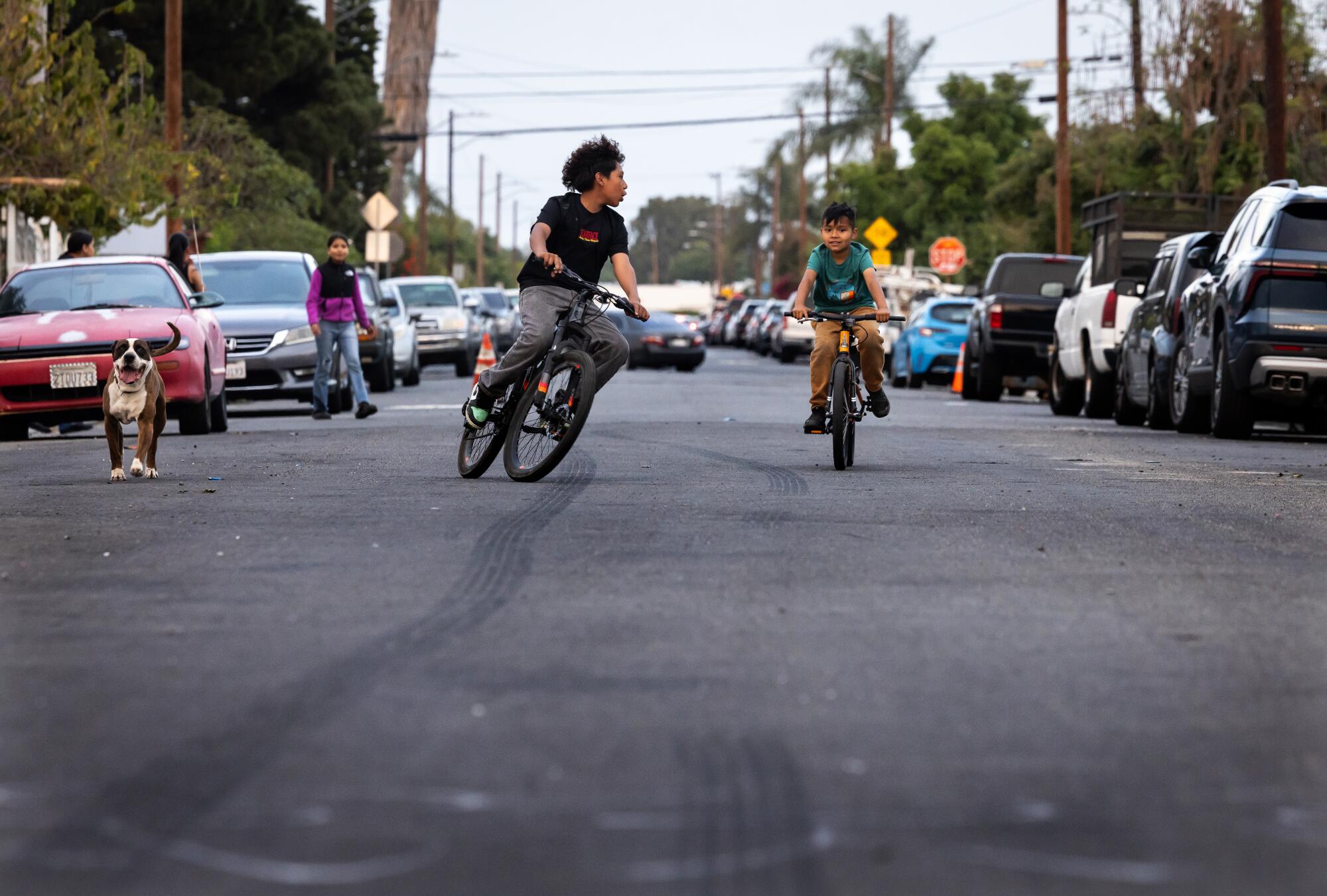 Children play in the street in the Artesia neighborhood where Father Cesar Galan once lived.