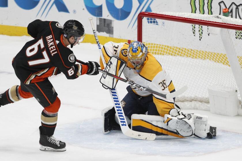 Anaheim Ducks' Rickard Rakell, left, of Sweden, scores against Nashville Predators goaltender Pekka Rinne, of Finland, in a shootout of an NHL hockey game, Monday, Nov. 12, 2018, in Anaheim, Calif. The Ducks won 2-1. (AP Photo/Jae C. Hong)