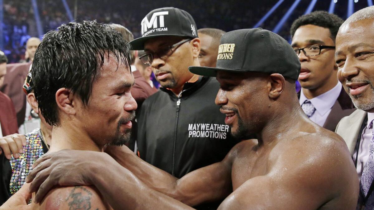 Manny Pacquiao, left, and Floyd Mayweather Jr. after their fight in 2015