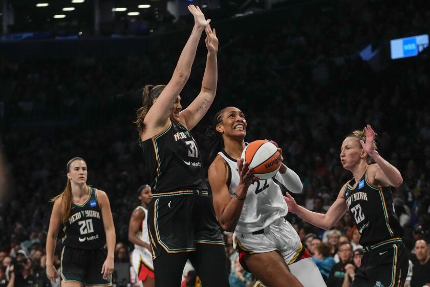 Las Vegas Aces' A'ja Wilson (22) drives to the basket as New York Liberty's Stefanie Dolson (31) and Courtney Vandersloot (22) defends during the first half in Game 4 of a WNBA basketball final playoff series Wednesday, Oct. 18, 2023, in New York. (AP Photo/Frank Franklin II)