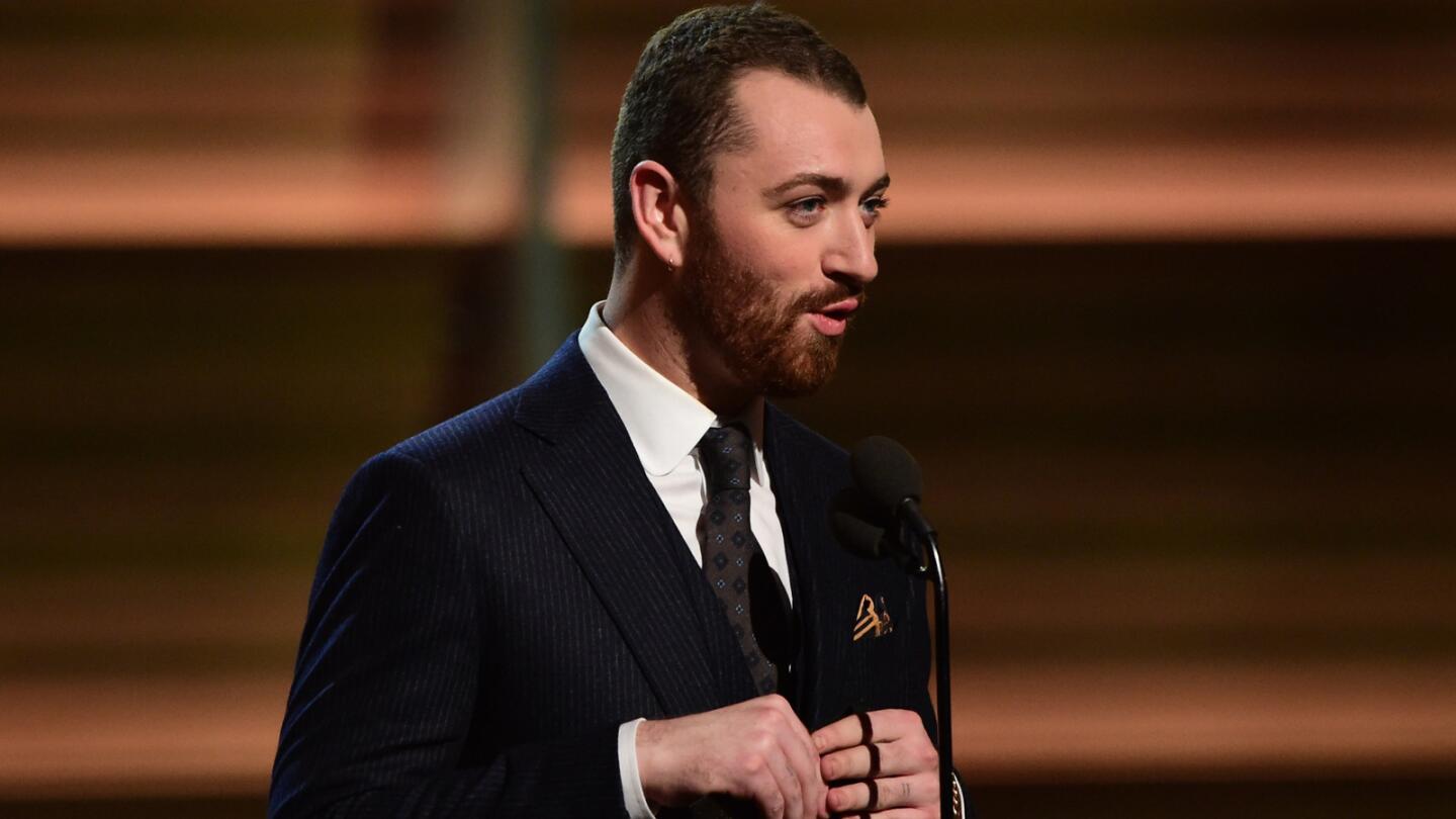 Sam Smith presents the award for best new artist onstage.