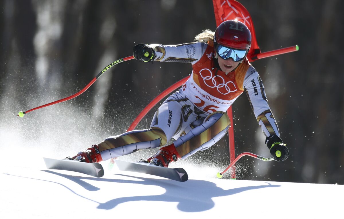 FILE- Czech Republic's Ester Ledecka competes in the women's super-G at the 2018 Winter Olympics in Jeongseon, South Korea, Saturday, Feb. 17, 2018. Double Olympic champion Ester Ledecka will spearhead a record number of Czech athletes at the forthcoming Winter Olympics at Beijing 2022. Ledecka will defend her two gold medals from the 2018 Winter Games in Pyeongchang. (AP Photo/Alessandro Trovati, File)