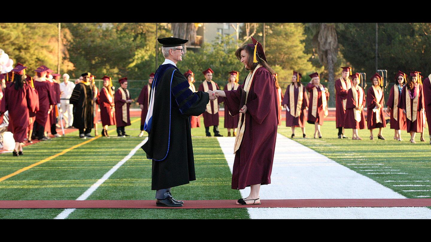 GCC graduate Narine Arushanyan shakes the hand of Superintendent-President Dr. David Viar after graduating at the graduation ceremony for Glendale Community College on Wednesday, June 14, 2017.