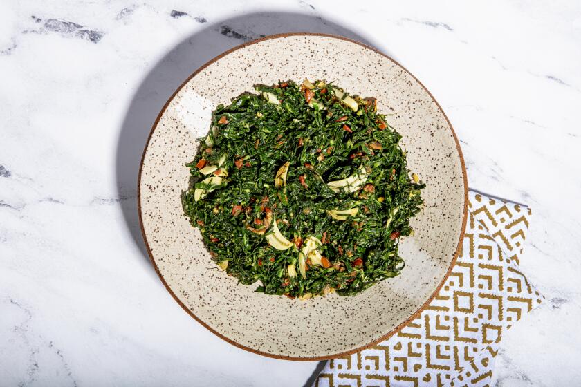 LOS ANGELES, CALIFORNIA, Dec. 11, 2020: A dish from food video-producer and cook Kiano Moju's Christmas menu: Sukuma Wiki (shredded and sauteed collard greens) photographed on Friday, Dec. 11, 2020, at Jikoni Studio, a creative culinary space owned by Moju, in Arts District Los Angeles. (Silvia Razgova / For the Times, food and prop styling by Kiano Moju) ATTN: 666808-la-fo-Kiano-Moju-Christmas