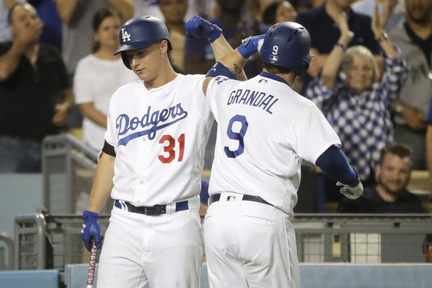 Dodgers' Yasmani Grandal, right, celebrates his home run with Joc Pederson during the seventh inning against the Tampa Bay Rays on Tuesday.
