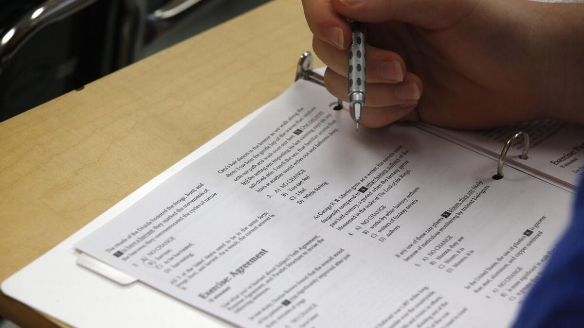 A student looks at questions during a college test preparation class at Holton-Arms School in Bethesda, Md.