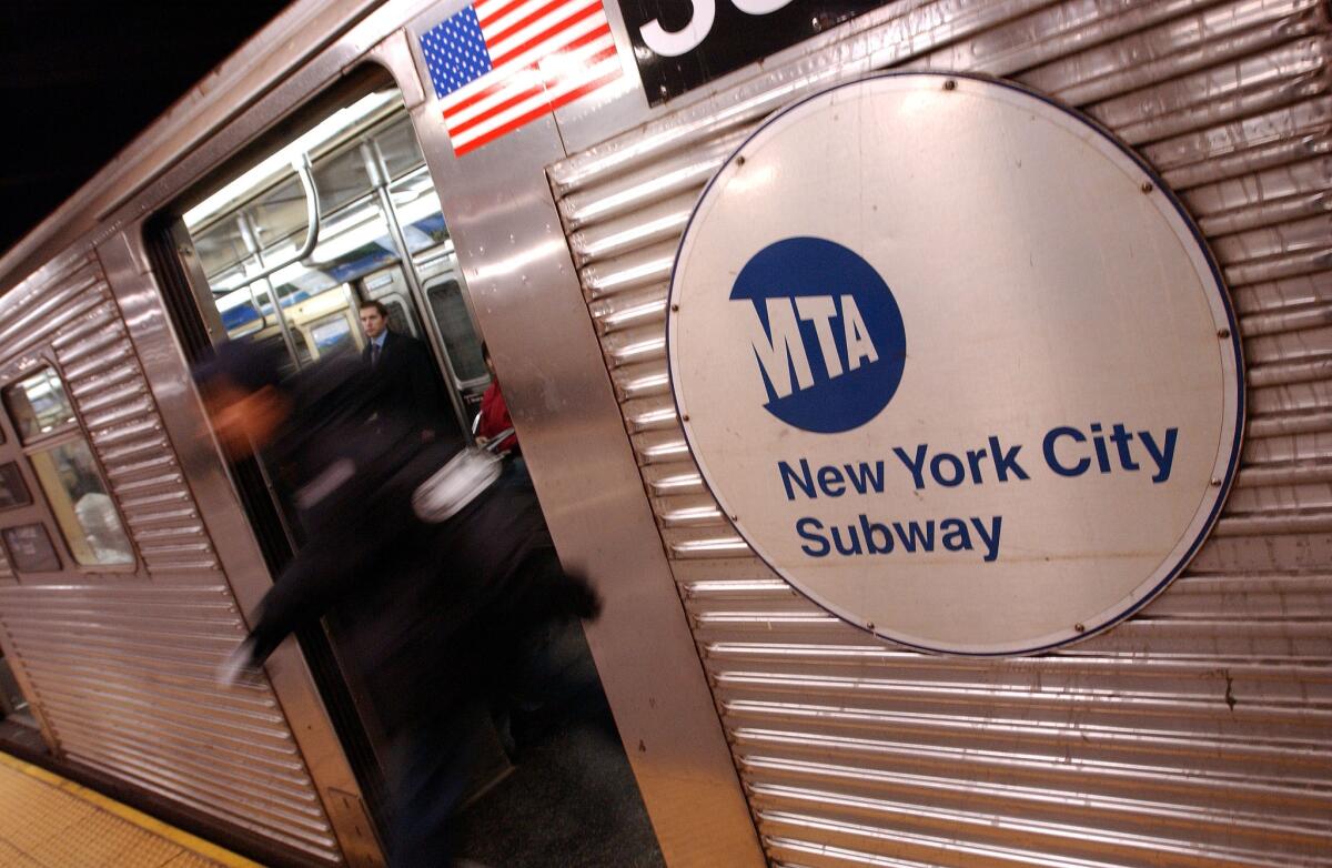 A man exits a subway in New York. The image of journalist James Foley, who was beheaded by Islamist militants, will be removed from a series of ads slated to appear in subway stations and on buses through the city.