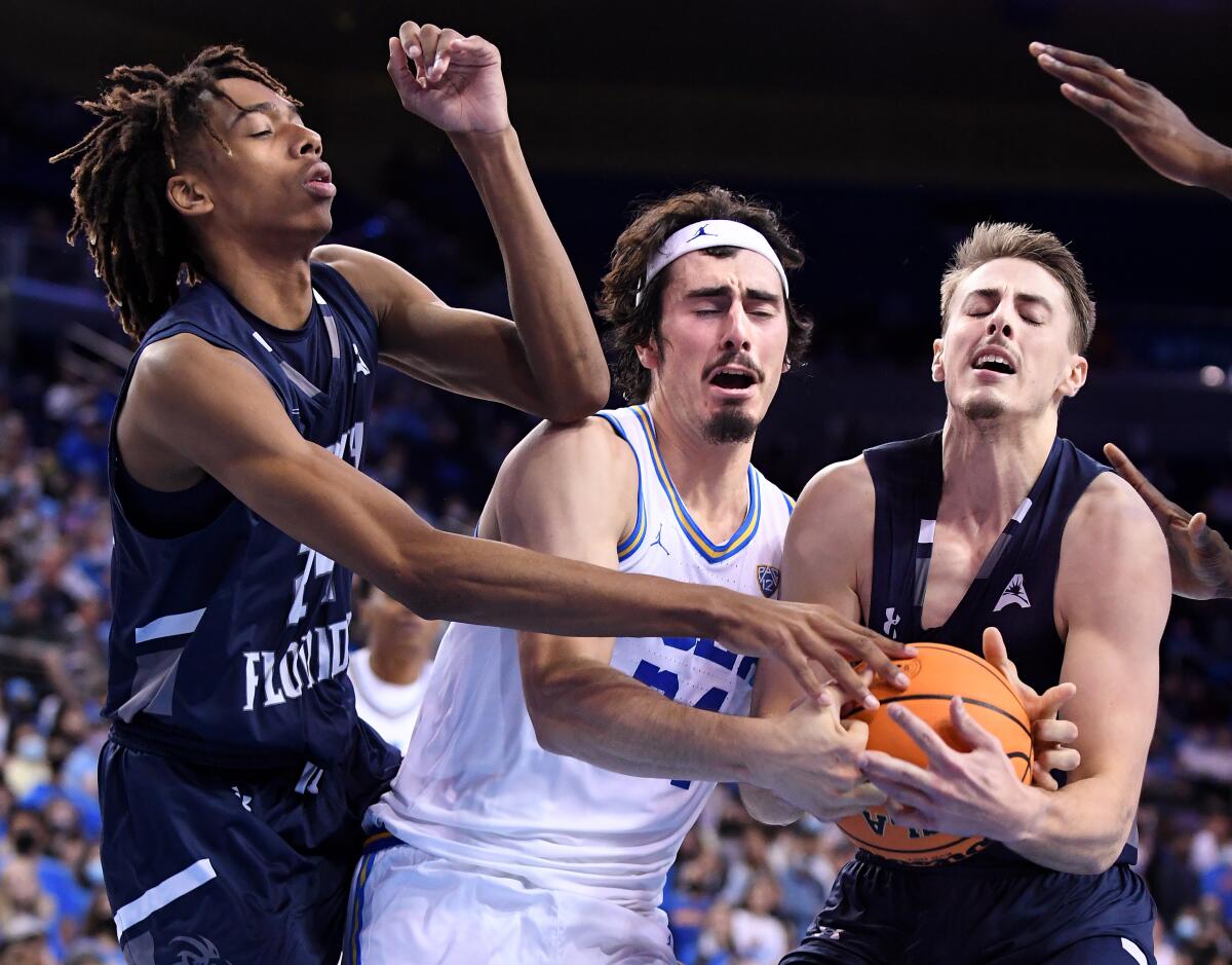 UCLA's Jaime Jaquez Jr. battles for the rebound with North Florida's Jadyn Parker and Carter Hendricksen.