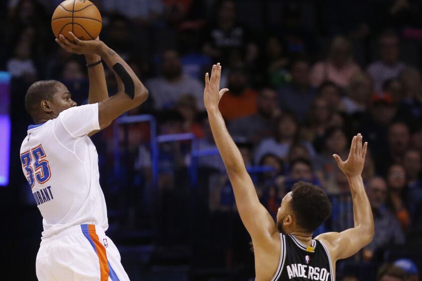 Thunder forward Kevin Durant rises up for a shot in front of Spurs forward Kyle Anderson during the third quarter of a game on March 26.