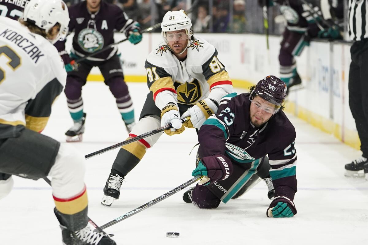 Ducks forward Mason McTavish chases the puck in front of Vegas Golden Knights right wing Jonathan Marchessault.