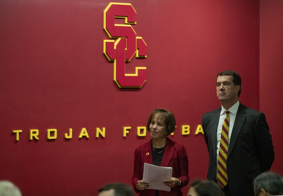 USC President Carol L. Folt, left, waits with new USC athletic director Mike Bohn, right, during news conference on the USC campus on Thursday.