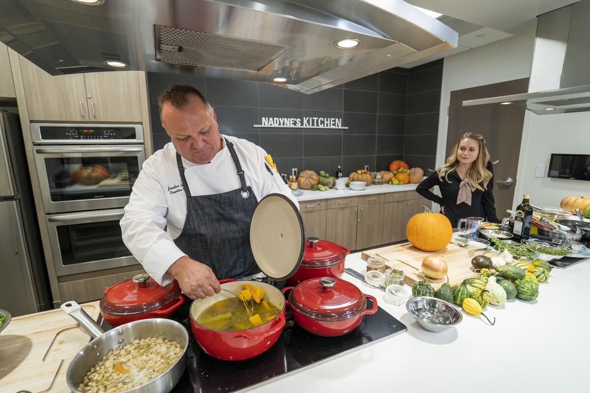 Chef Jonathan Gelman, left, checks on a dish as Kailey Proctor looks on at the Leonard Cancer Institute.