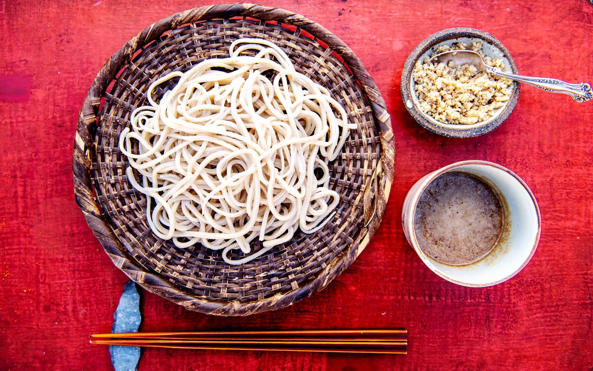 Homemade soba noodles, pictured with a walnut dipping sauce.