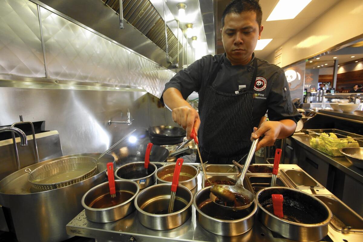 Panda Express made its reputation on orange chicken — its bestselling item — and the fresh-cut ingredients in the Rosemead chain’s Chinese stir-fry. Above, the Panda Express Innovation Kitchen in Pasadena.