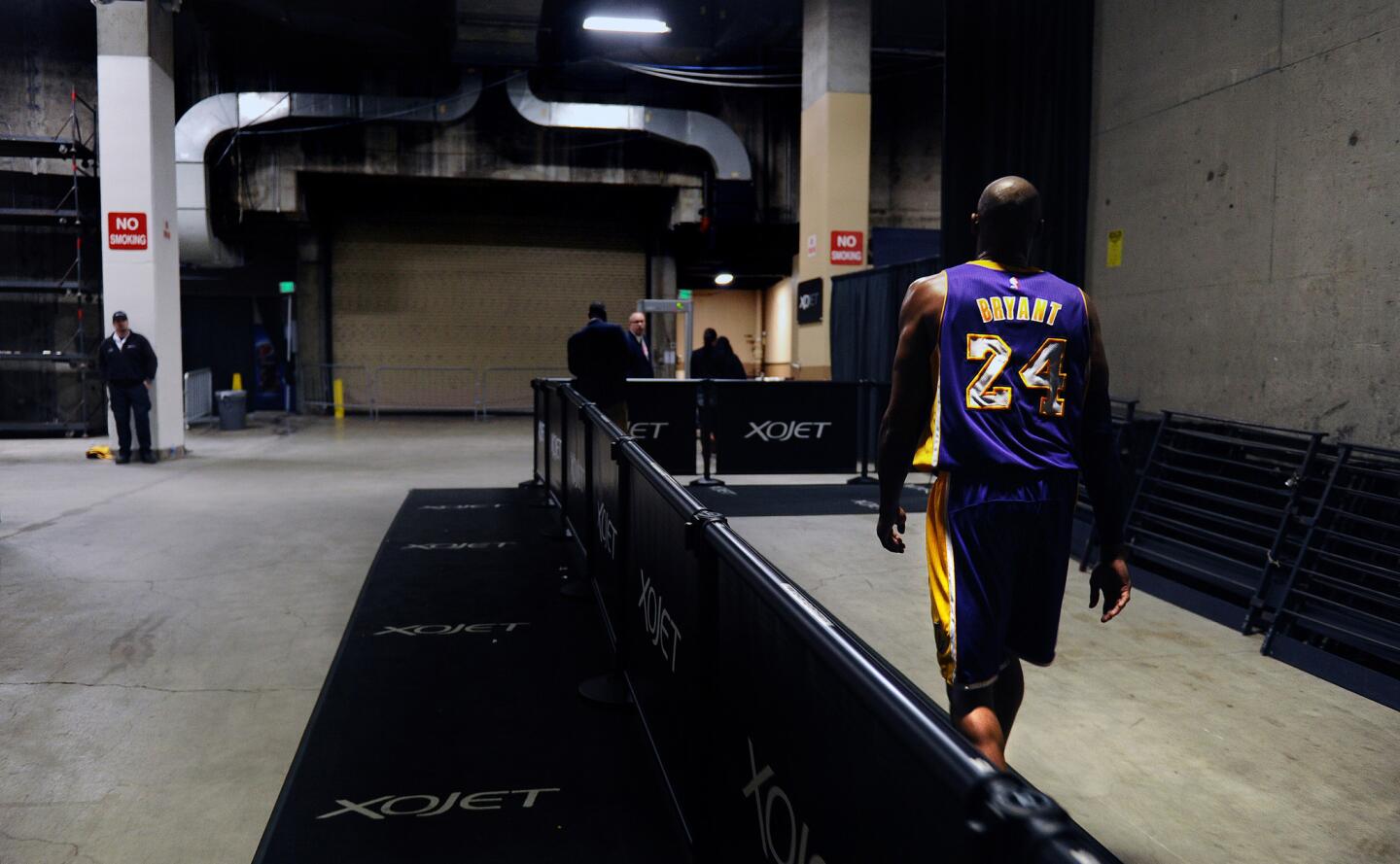 Kobe Bryant heads to the Oracle Arena locker room after the Lakers lost the Warriors, 116-98, in his final game in Oakland on Jan. 14, 2016.