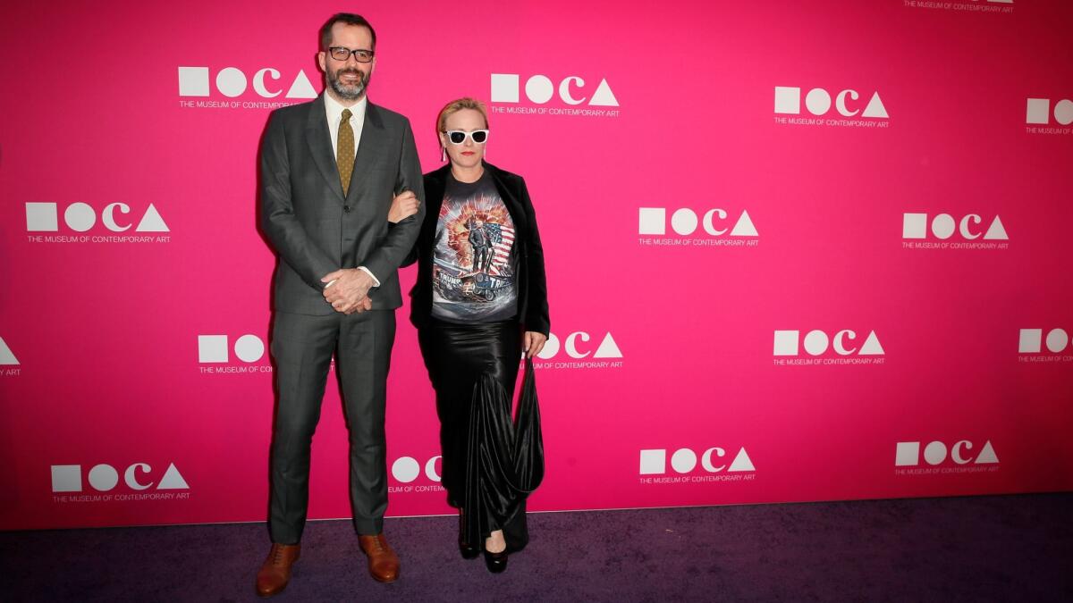 Patricia Arquette, right, with artist Eric White, wins the MOCA Gala red carpet with her T-shirt featuring Trump on a tank.