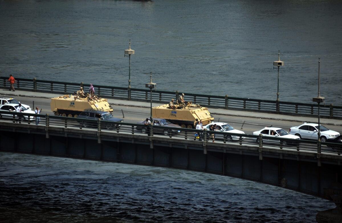 Egyptian army tanks drive on a bridge over the Nile River following an assault on supporters of ousted President Mohammed Morsi.