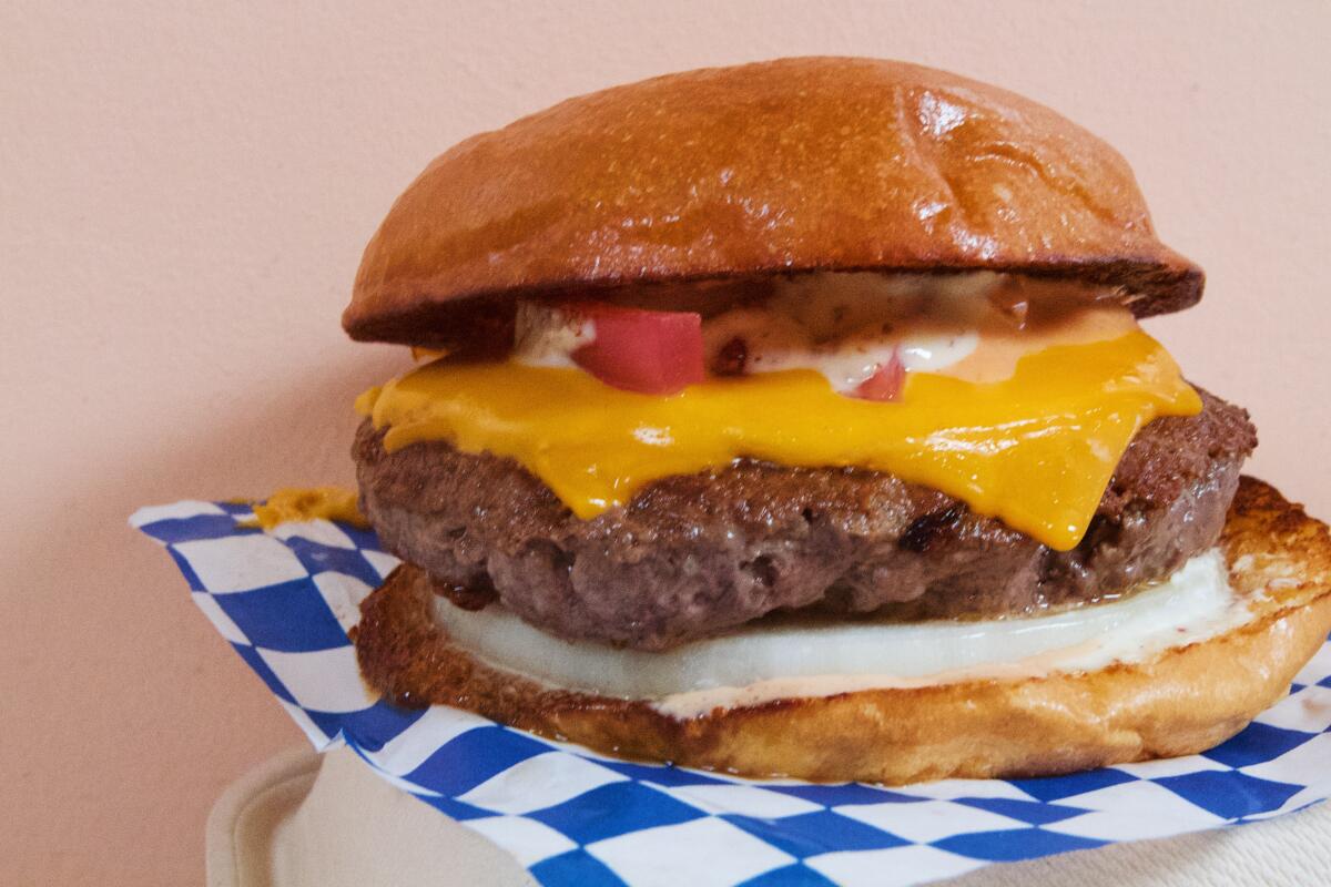 A horizontal closeup of the Bar Burger cheeseburger from Goldburger.