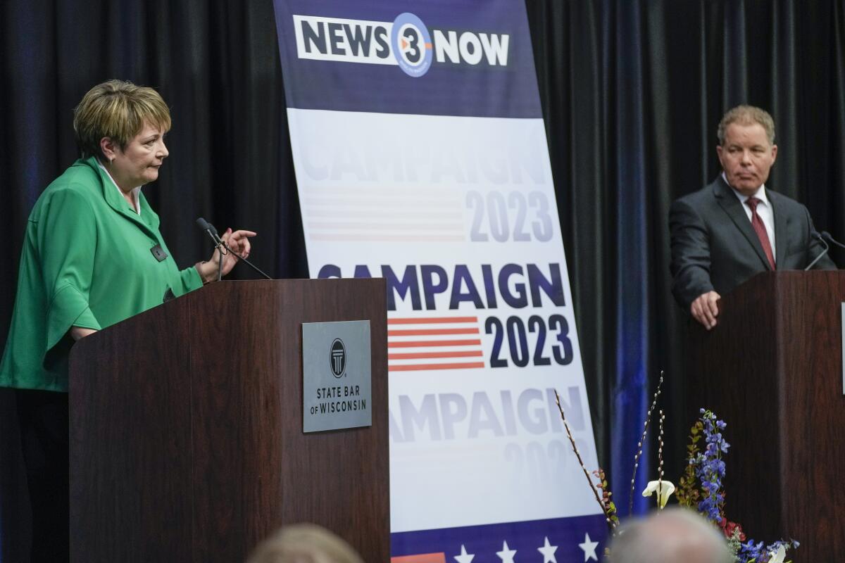 Wisconsin Supreme Court candidate Janet Protasiewicz, left, and opponent Dan Kelly, right, at a debate.