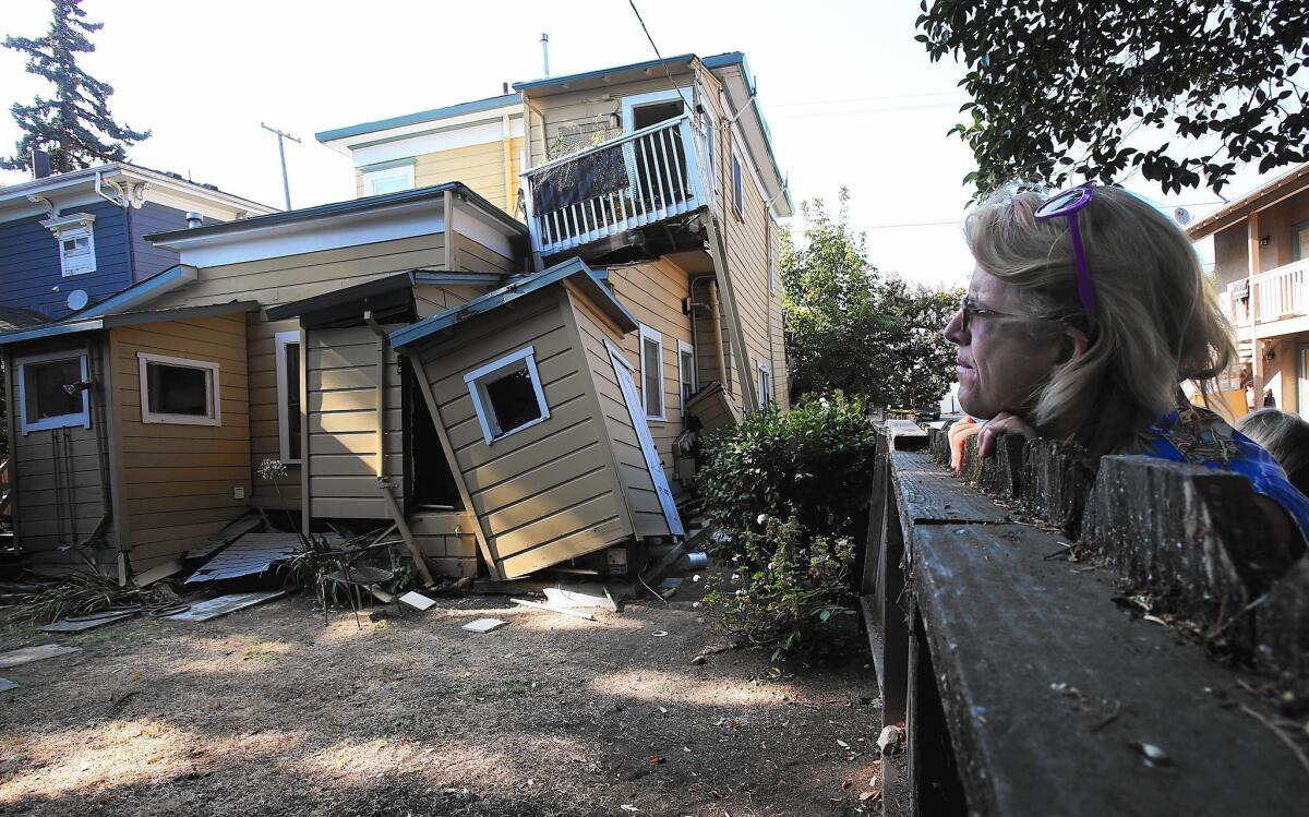 Vickie Katsubayashi looks at a red-tagged home near downtown Napa after the 6.0-magnitude earthquake in August.