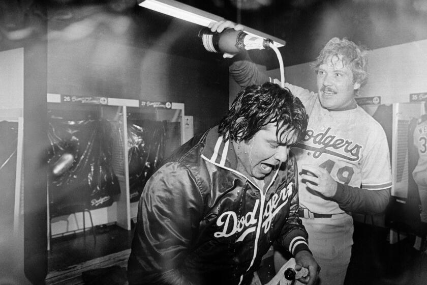 Los Angeles Dodgers pitcher Fernando Valenzuela is doused with champagne by teammate Tom Niedenfuer after the Dodgers won the National League title over the Expos on Oct. 20, 1981, in Montreal, Canada. Valenzuela got the win in the 2-1 Dodger victory. (AP Photo/MacAlpine)