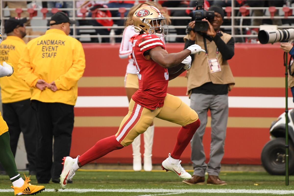 San Francisco running back Raheem Mostert rushes for one of his four touchdowns against the Green Bay Packers during the NFC championship game Sunday at Levi's Stadium.