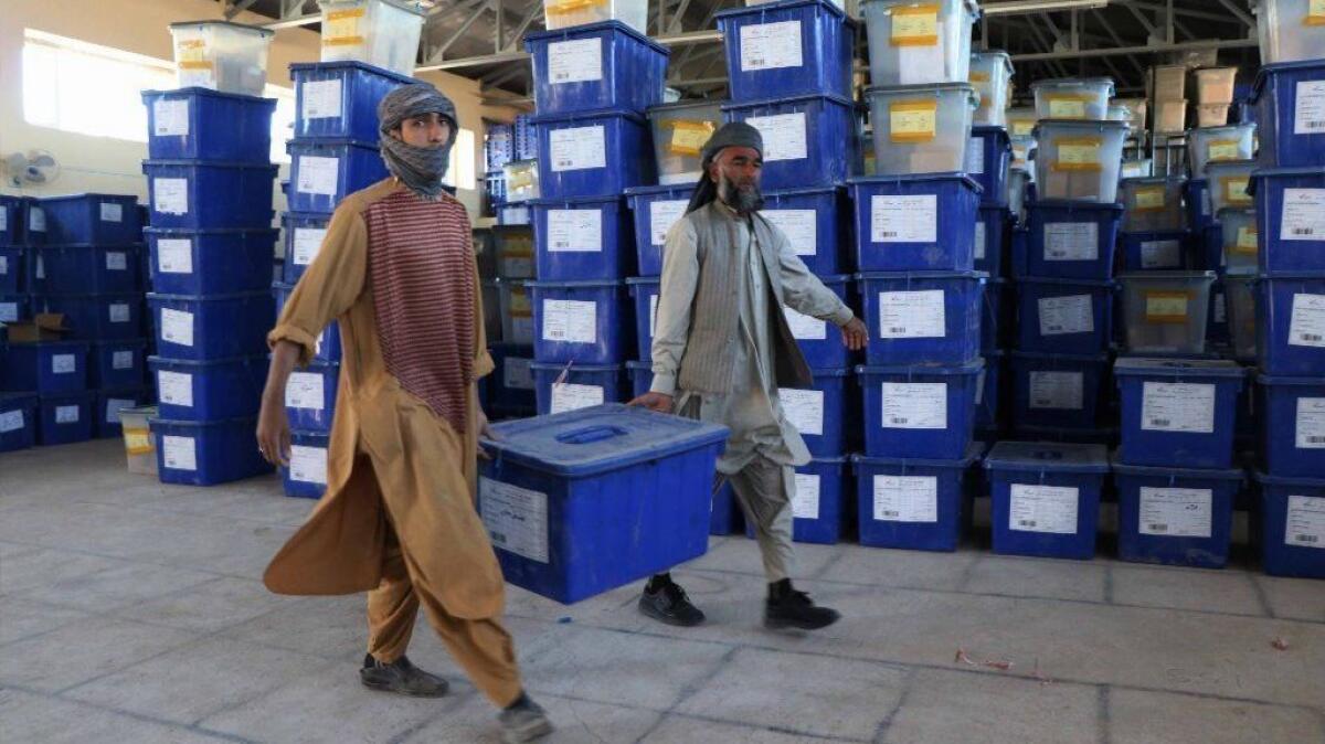 Employees of Afghanistan's Independent Election Commission carry ballot boxes to a warehouse in Herat, Afghanistan.