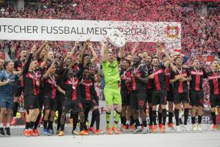 Jugadores del Bayer Leverkusen celebran con el trofeo de campeón de la Bundesliga al final del encuentro ante el Augsburg en el BayArena en Leverkusen, Alemania el sábado 18 de mayo del 2024. (AP Foto/Martin Meissner)