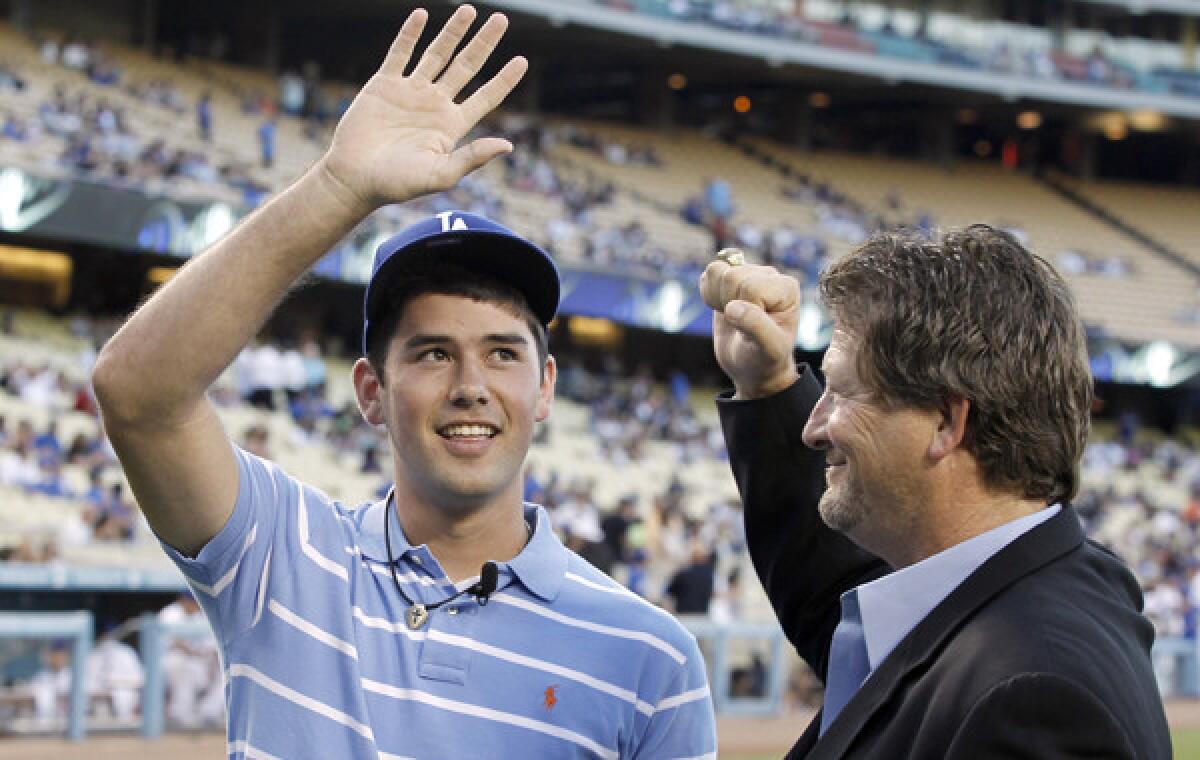 Dodgers assistant general manager Logan White, right, introduces Zach Lee to fans at Dodger Stadium during a game against the Colorado Rockies in August 2010.