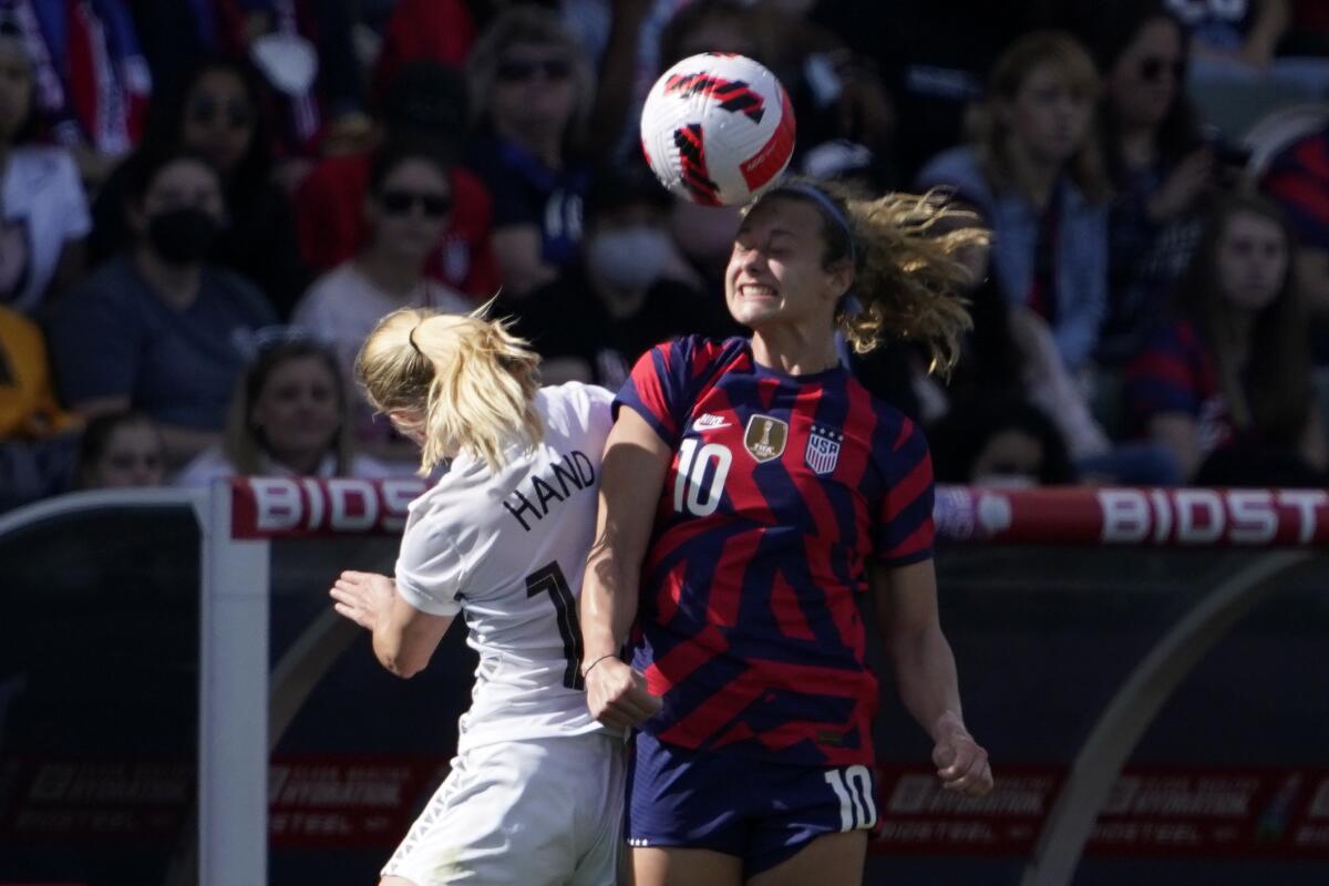 New Zealand forward Jacqui Hand and U.S. midfielder Jaelin Howell try to head the ball.