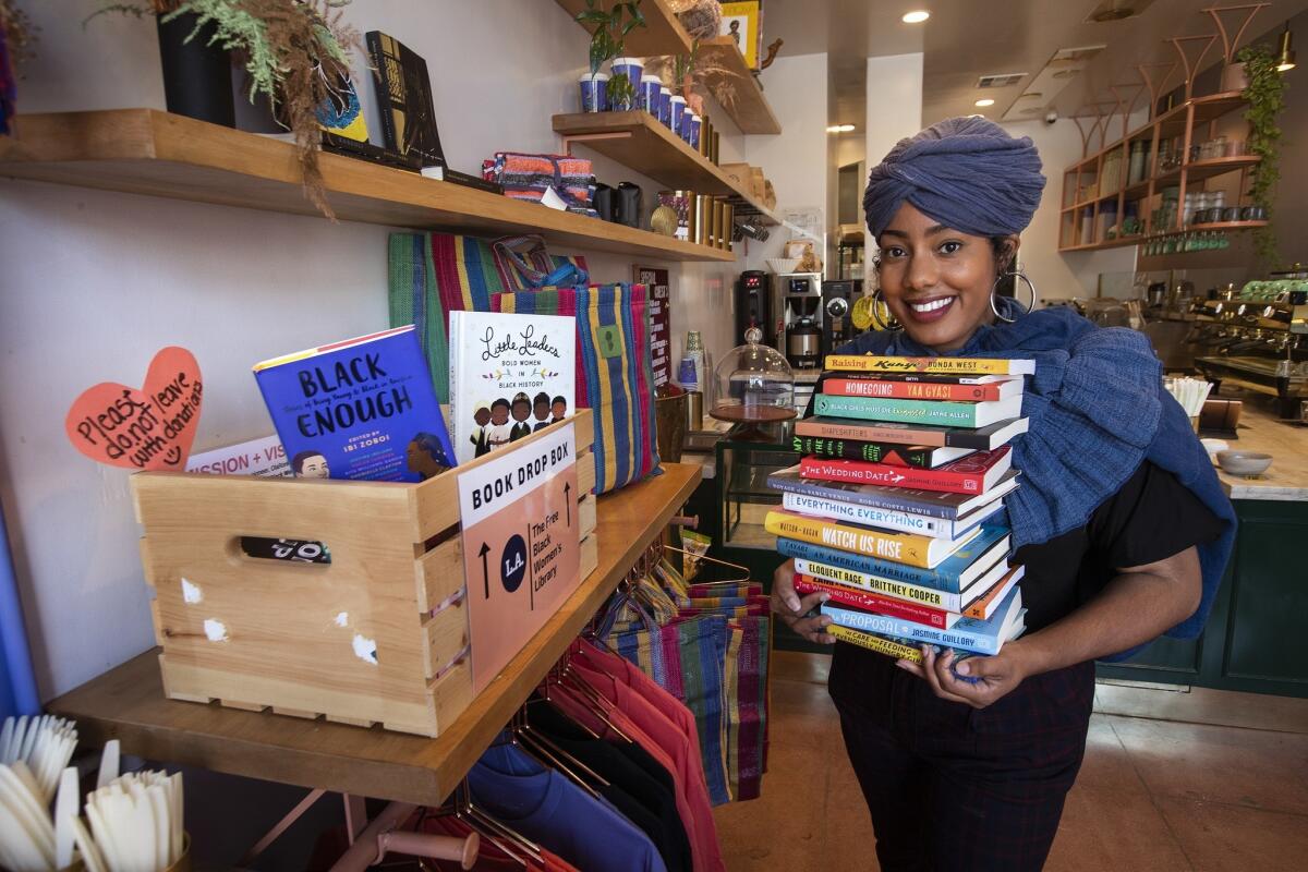 Asha Grant, founder of the L.A. chapter of the Free Black Women's Library, at a lending library inside Bloom and Plume, a black-owned coffee shop on Temple Street.