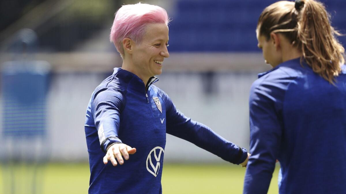 Megan Rapinoe, left, and Tobin Heath share a laugh during the U.S. training session on Saturday in Reims, France.